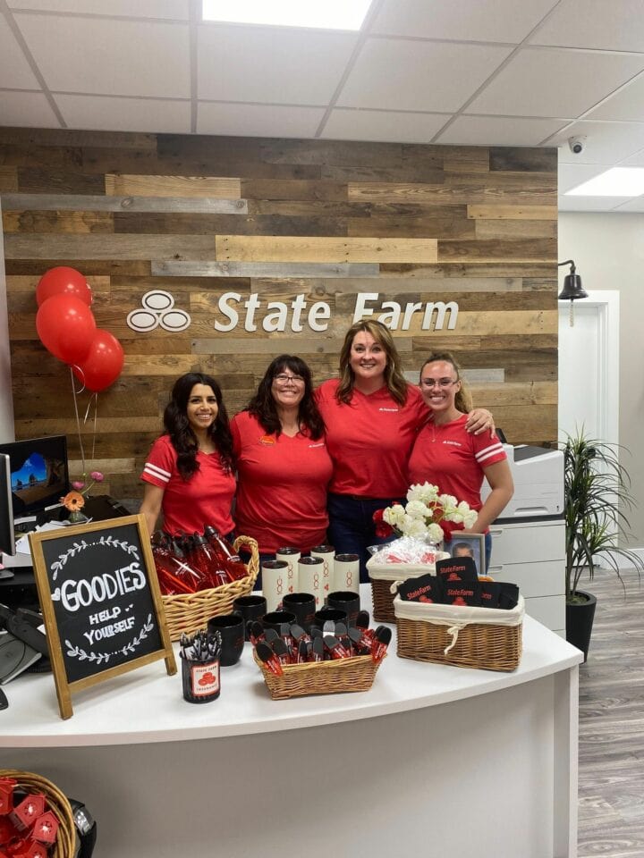 Women posing at State Farm front desk